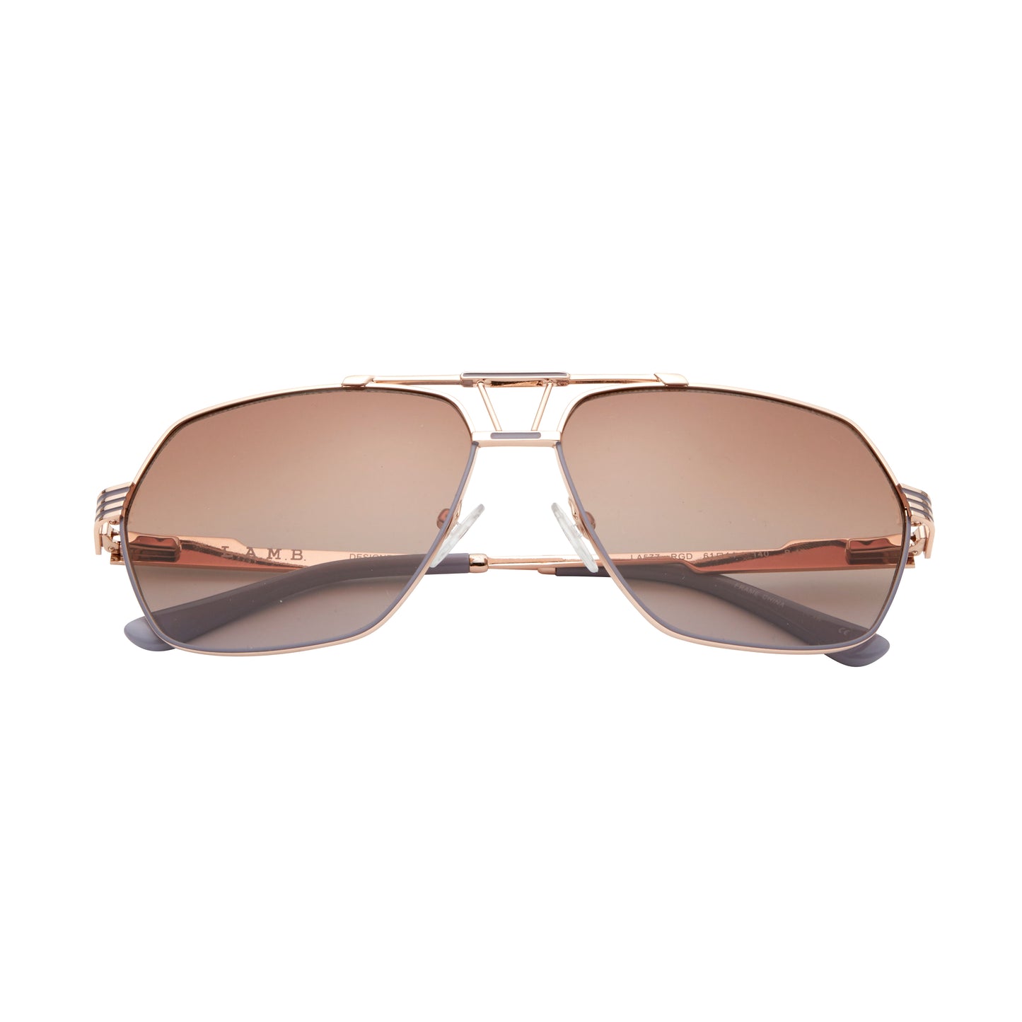 L.A.M.B. LA577 RGD sunglasses with a geometric aviator rose gold metal frame, gradient brown lenses, signature cutout bridge design, and sleek striped temples with grey temple tips. Front view.