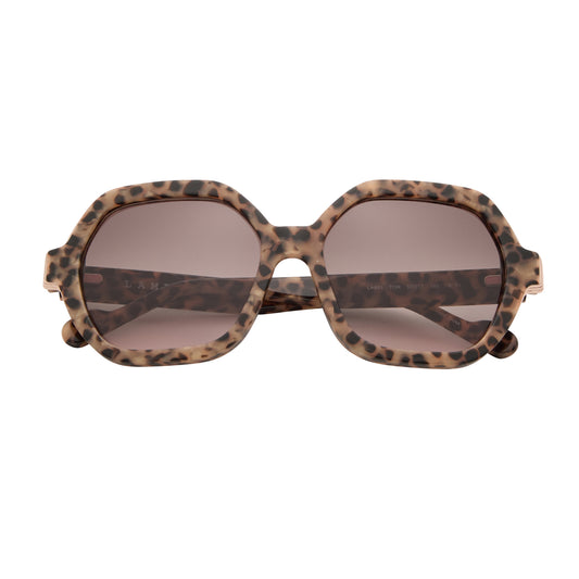 Front view of L.A.M.B. LA601 TOR Sunglasses featuring oversized tortoise frame, gold detailing, brown to blush gradient lenses, luxury acetate, size 57-17-145.