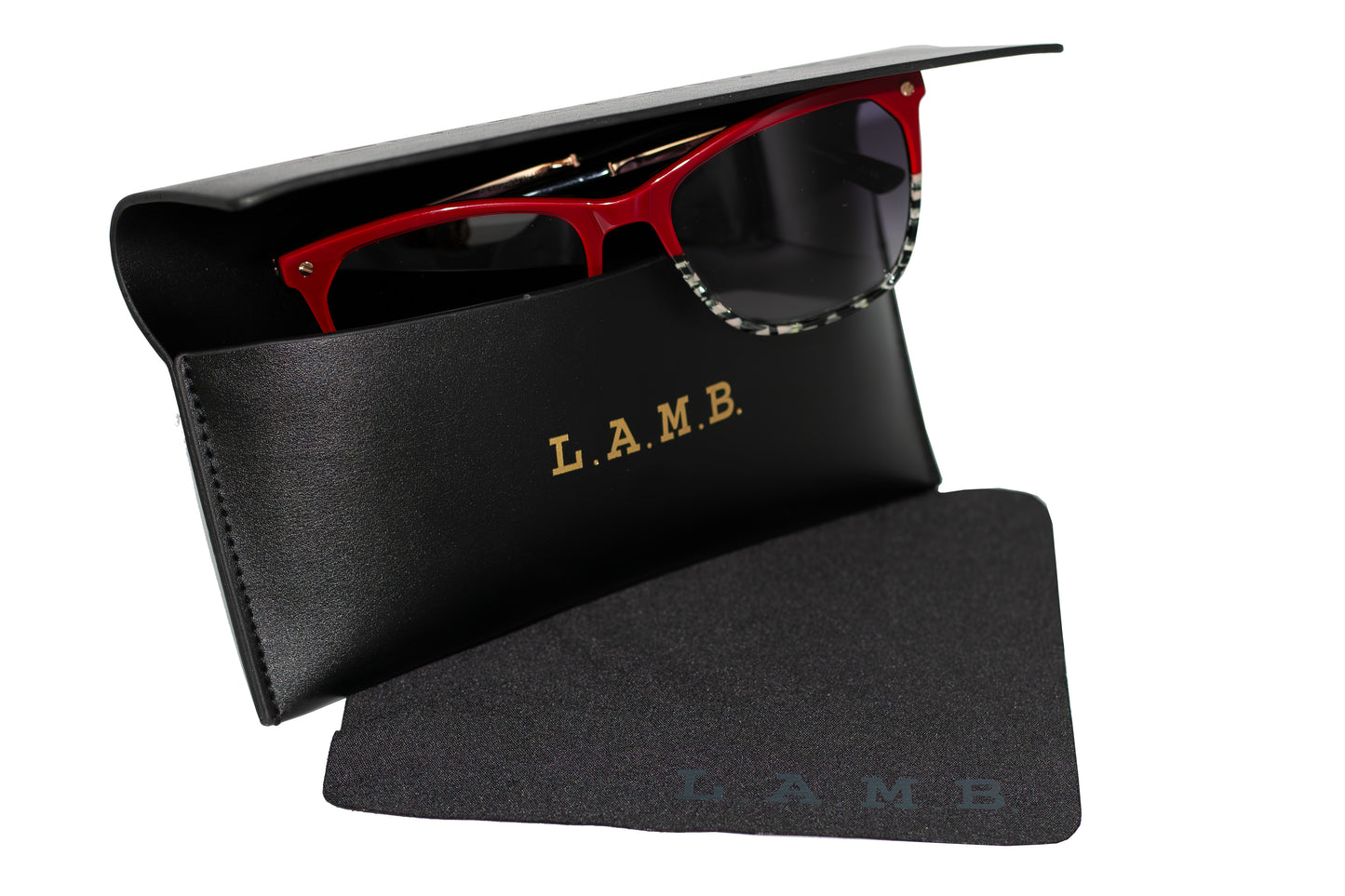 Black L.A.M.B. designer eyeglass case with embossed logo and matching branded cleaning cloth, perfect for stylish eyewear protection and storage.