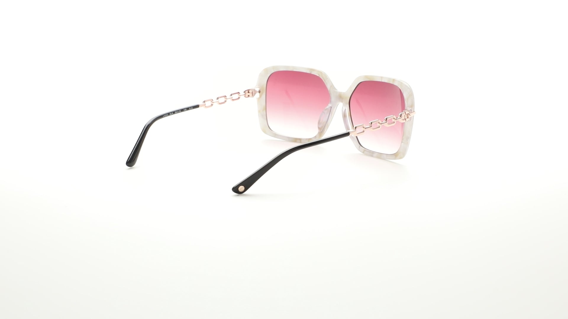 L.A.M.B. LA599 black sunglasses – oversized square frames with gradient brown lenses, rose gold chain-link temples, and sleek black finish, designed by Gwen Stefani. 360 view.