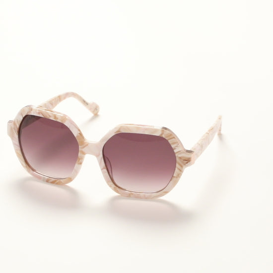 360-degree view of L.A.M.B. LA601 BLS Sunglasses in oversized blush marble acetate frame with elegant gold front detail and burgundy gradient lenses, 100% UVA+UVB protection.